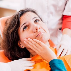 Woman in the dental chair with a toothache
