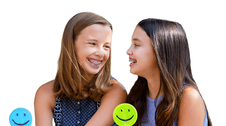 Two smiling young girls with braces